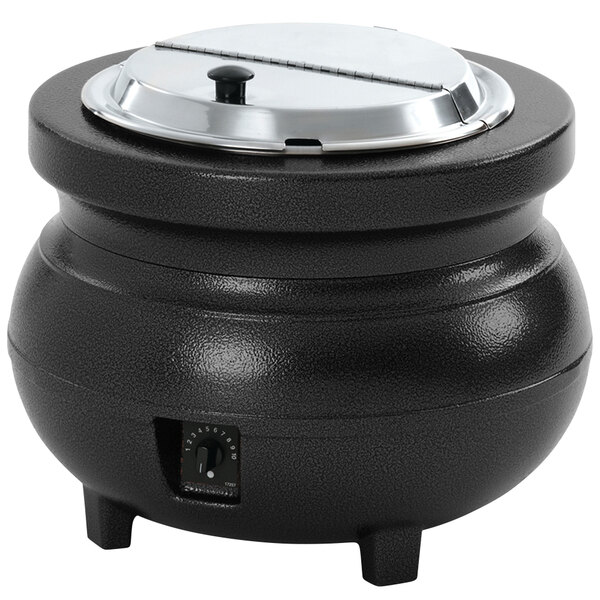 A black Vollrath soup kettle with a silver lid on a countertop.