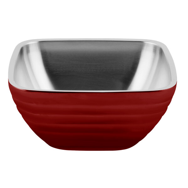 A red Vollrath beehive serving bowl with a stainless steel rim.