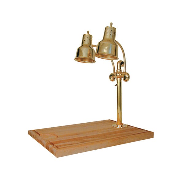 A brass Hanson Heat Lamp carving station on a wooden surface.