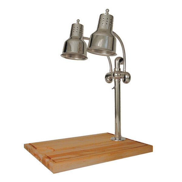 A Hanson Heat Lamps chrome carving station with two heat lamps on a maple block with metal gravy lanes.