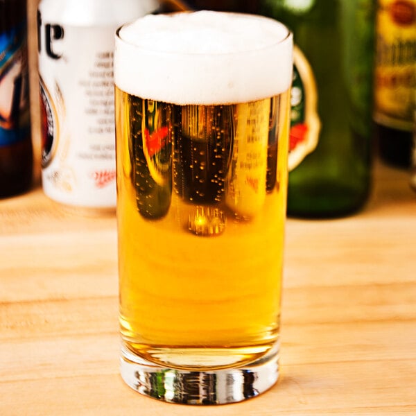 A Libbey Lexington cooler glass filled with beer on a table.