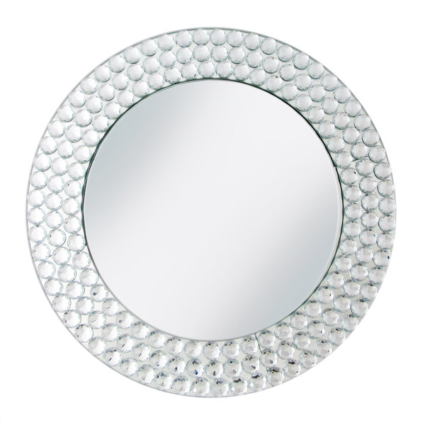 A round mirror charger plate with white dots around the edge.