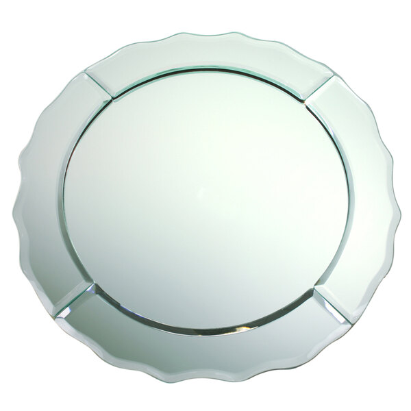 A close-up of a scalloped glass mirror charger plate with a white background.