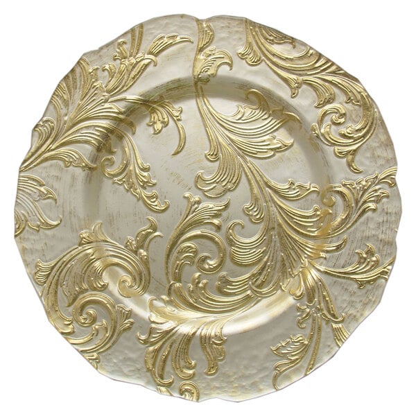 A white round charger plate with a gold swirl design.