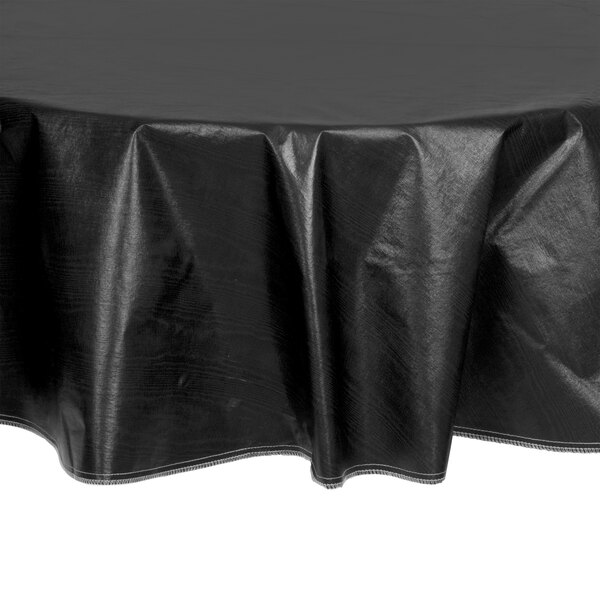 A black Intedge vinyl round table cover with flannel back on a round table.