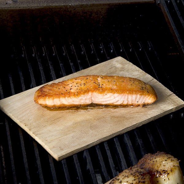 Cooked salmon on an American Metalcraft cedar wood grilling plank.