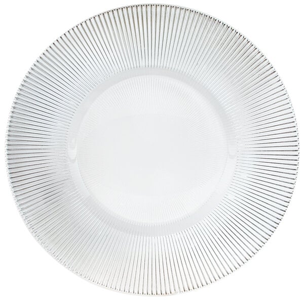 A clear glass charger plate with a circular pattern of thin lines.