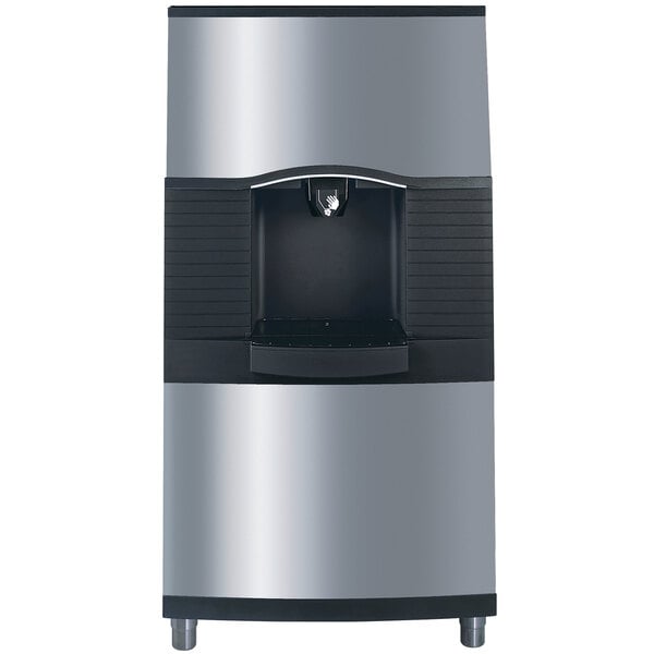 A black and silver Manitowoc ice dispenser with a water valve.
