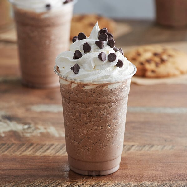 A cup of Big Train Java Chip Blended Ice Coffee with whipped cream and chocolate chips.