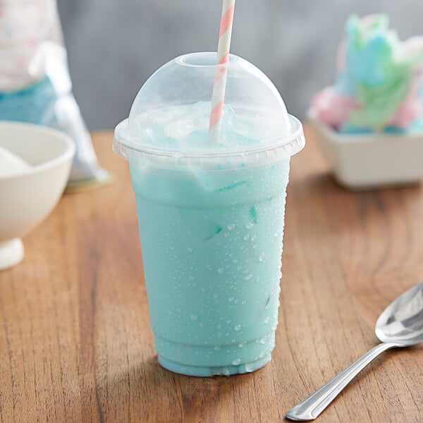 A blue drink in a plastic cup with a straw.