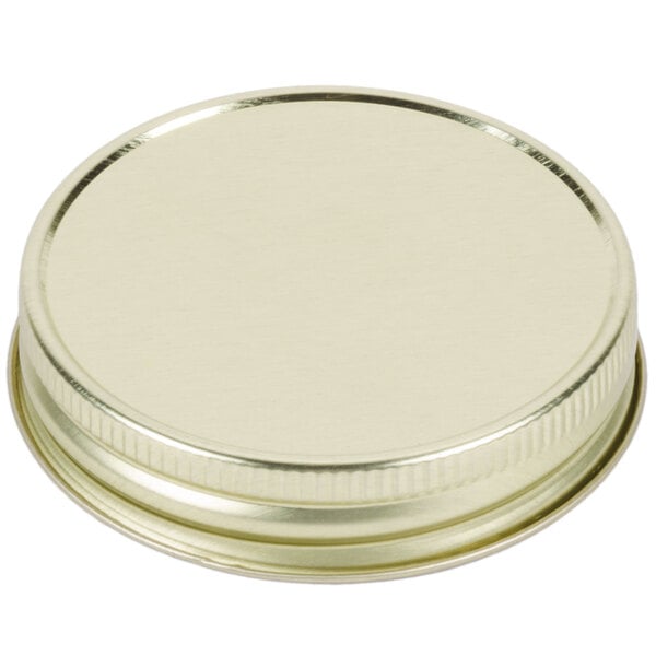 A gold metal Libbey Mason Jar lid.