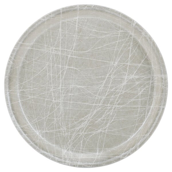 A white round Cambro fiberglass tray with a gray abstract design.
