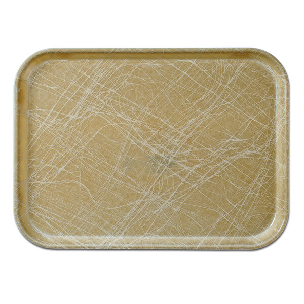 A rectangular Cambro tan fiberglass tray with white lines on a brown surface.