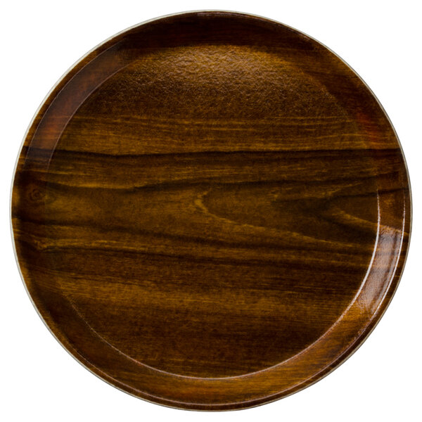 A round Cambro fiberglass tray with a Burma Teak wood grain finish.