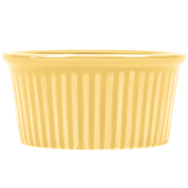 A yellow fluted ramekin with a striped pattern.