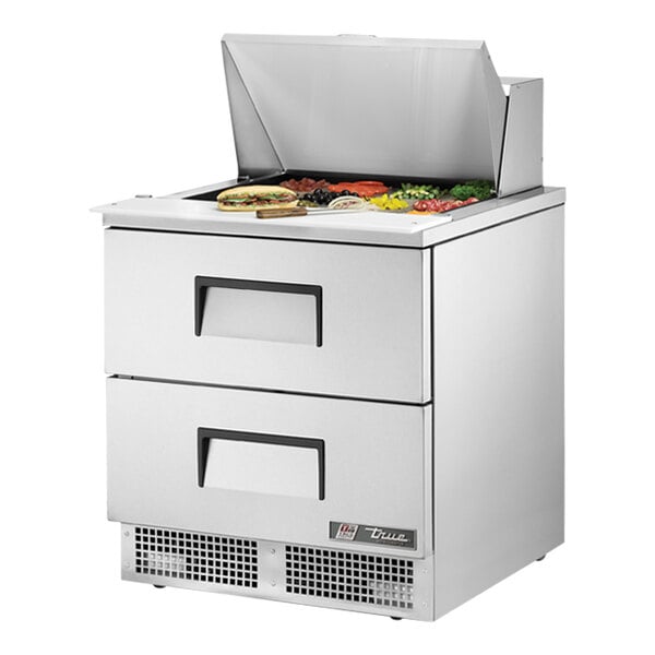 A True refrigerated sandwich prep table with a stainless steel counter and two drawers.