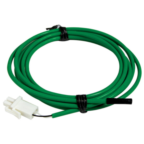 A green cable with a white connector on a green surface.