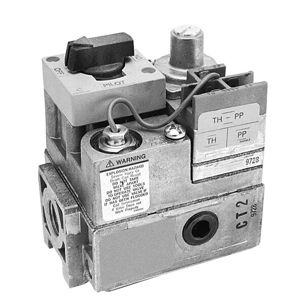 A close-up of a grey mechanical device with a red pressure switch.