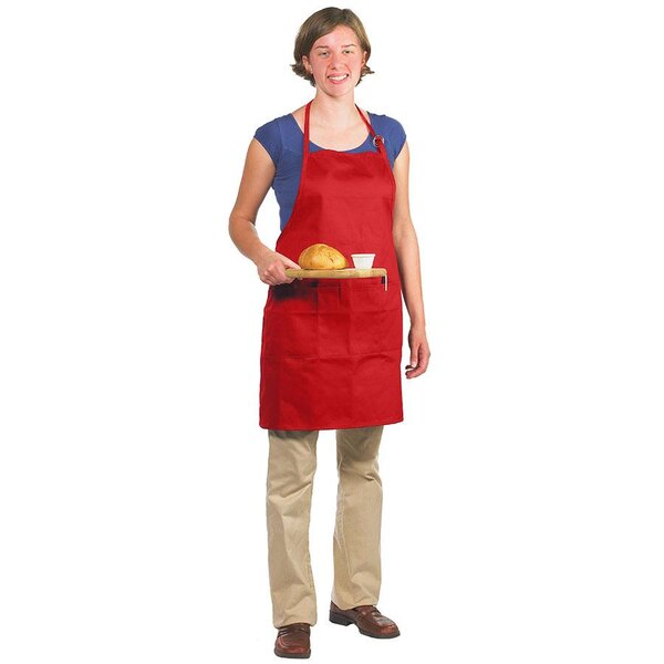 A woman wearing a red Chef Revival bib apron holding a plate of food.
