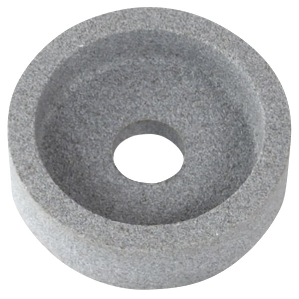 A circular grey sharpening stone with a hole in the middle.