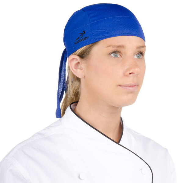 A woman wearing a blue Headsweats chef bandana.