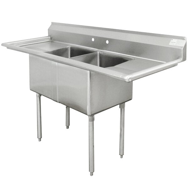 An Advance Tabco stainless steel commercial sink with two bowls and two drainboards.