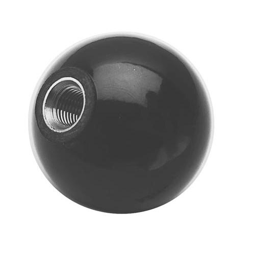 A black round object with a metal nut on it.
