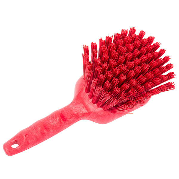 A Carlisle Sparta red utility brush with a handle and long bristles.