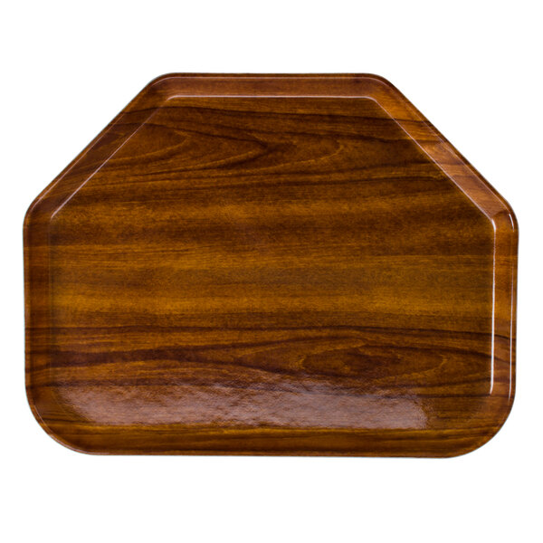A trapezoid shaped wooden Cambro tray on a table.