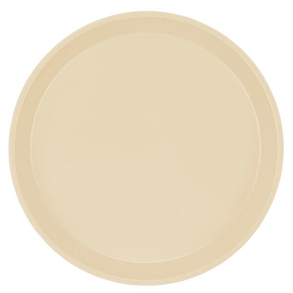 A beige fiberglass tray with a round rim on a white surface.