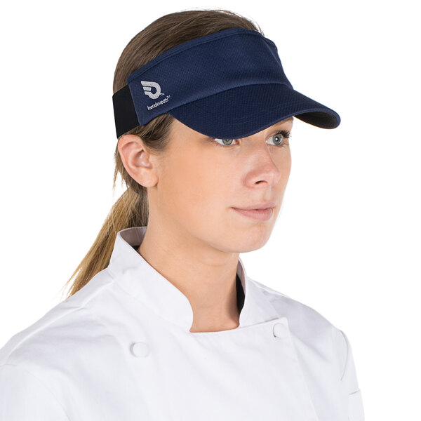 A woman wearing a navy blue Headsweats visor.