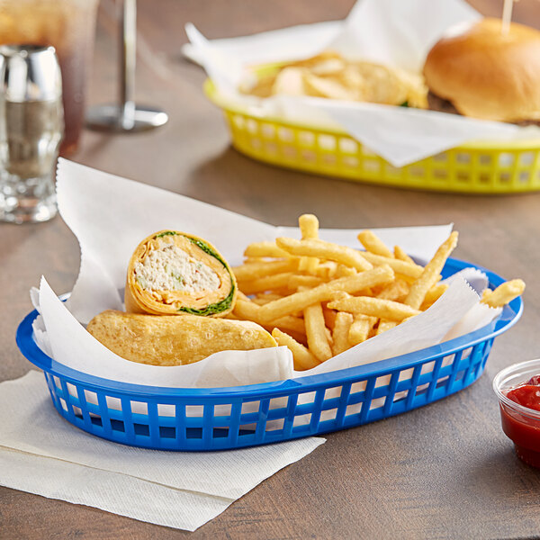 A Tablecraft blue oval platter basket filled with burgers and fries on a table.