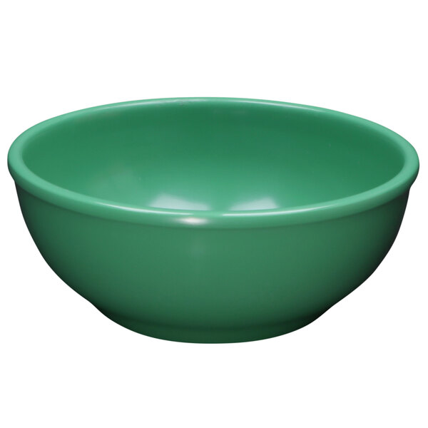 An Elite Global Solutions Rio Autumn Green melamine bowl with a green surface and white spot.
