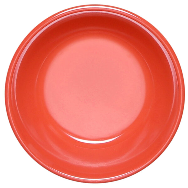 A close-up of a red melamine monkey dish with a white background.