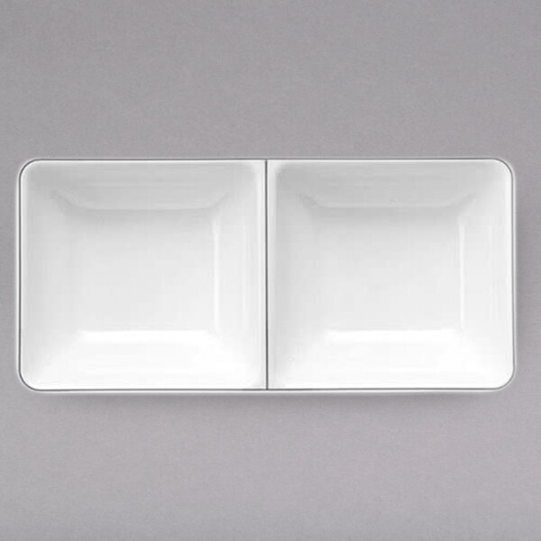 A white rectangular melamine ramekin with two compartments.
