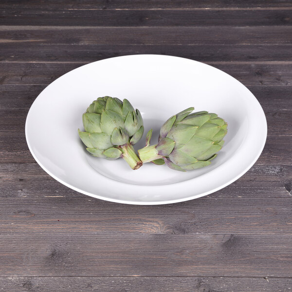 Elite Global Solutions white melamine bowl filled with artichokes on a wood table.