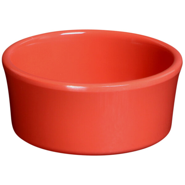 A coral ramekin with a white background.