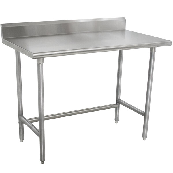 A stainless steel Advance Tabco work table with a backsplash.