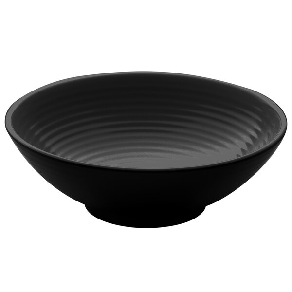 A black melamine bowl with wavy lines on it.