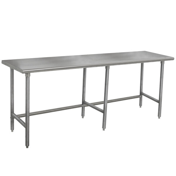 A stainless steel Advance Tabco work table with an open base and long legs.