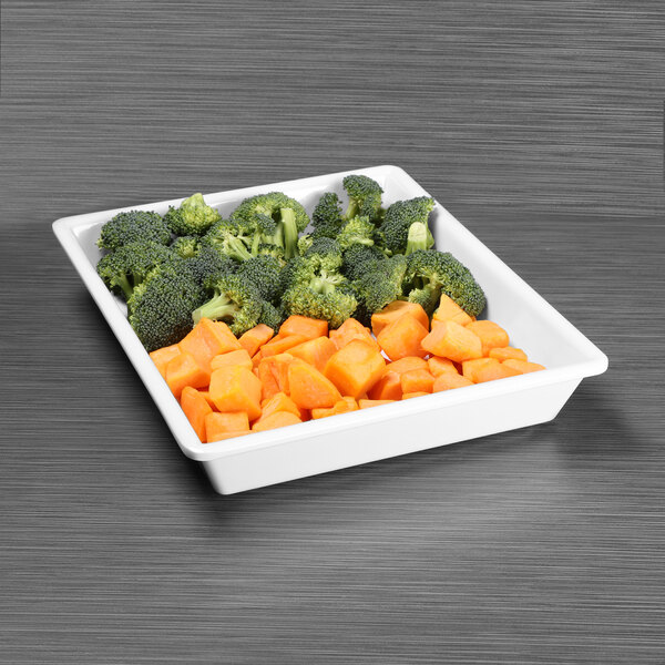 A white tray with broccoli and carrots.