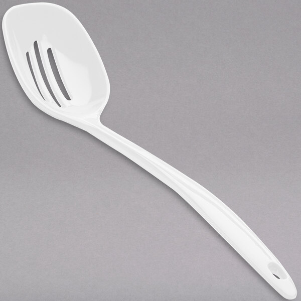 A white plastic slotted spoon with a handle.