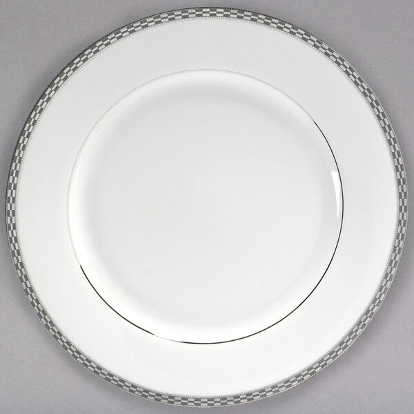 A white porcelain charger plate with a grey and white border.