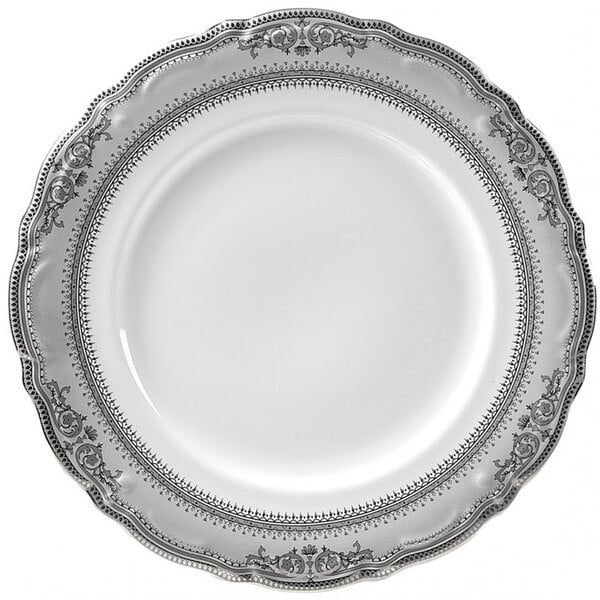 A white porcelain charger plate with a silver border and ornate design.