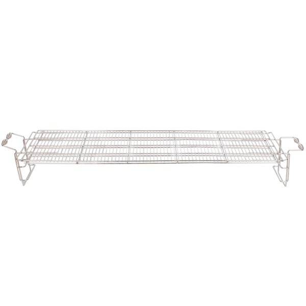 A metal cooking grate with handles.