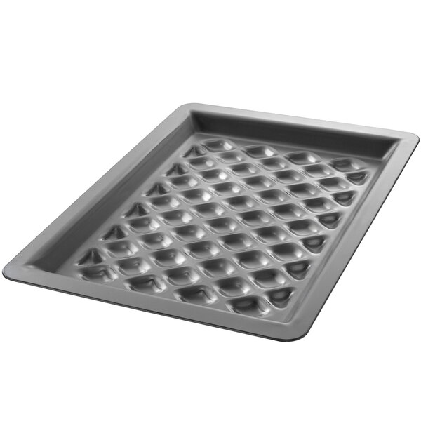 A Chicago Metallic anodized aluminum diamond grill pan with holes in it.
