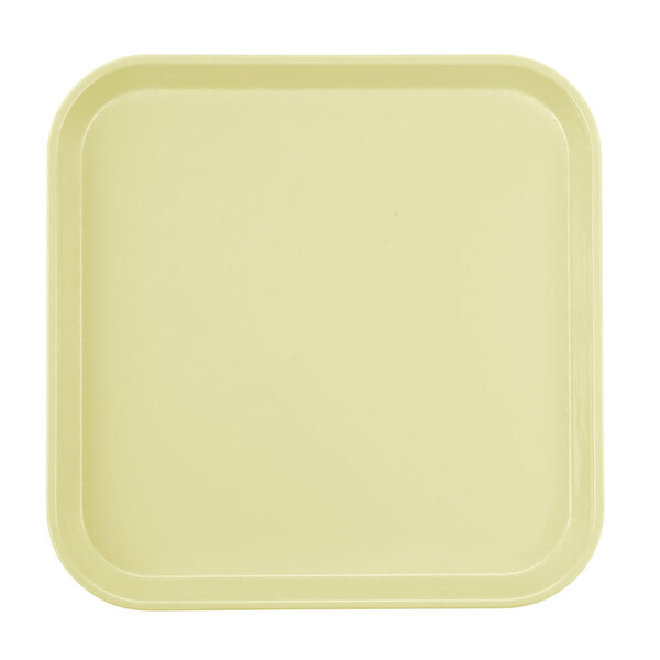 A white surface with a square yellow Cambro tray with a yellow border.