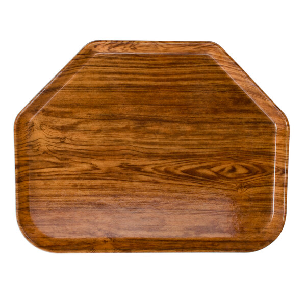 A Cambro java teak fiberglass trapezoid tray on a table.