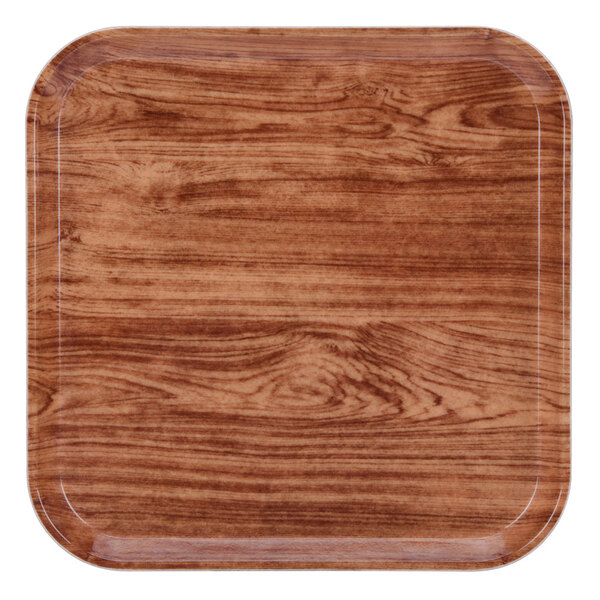A square Java teak tray with a wood finish.