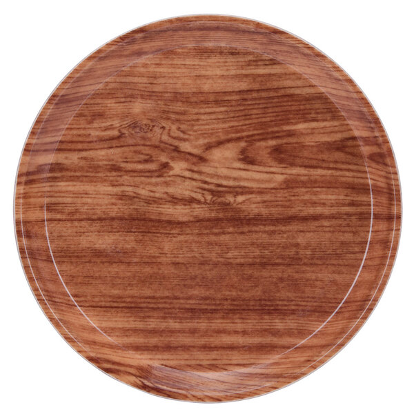 A round wooden Cambro tray with a white rim.